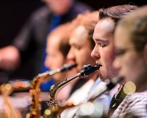 Members of the UW Jazz Orchestra, including Ryan Kimbrell (center) on alto and soprano saxophone, practice during a rehearsal session with guest artist and saxophonist Bob Sheppard and Johannes Wallmann, UW director of Jazz Studies, inside Music Hall at the University of Wisconsin-Madison on April 29, 2016. Members of the UW High School Honors Jazz Band and the UW Jazz Orchestra performed in a public concert with Bob Sheppard later that evening. (Photo by Bryce Richter / UW-Madison)